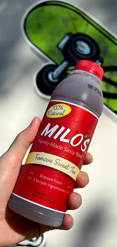 A hand holding Milo's tea.