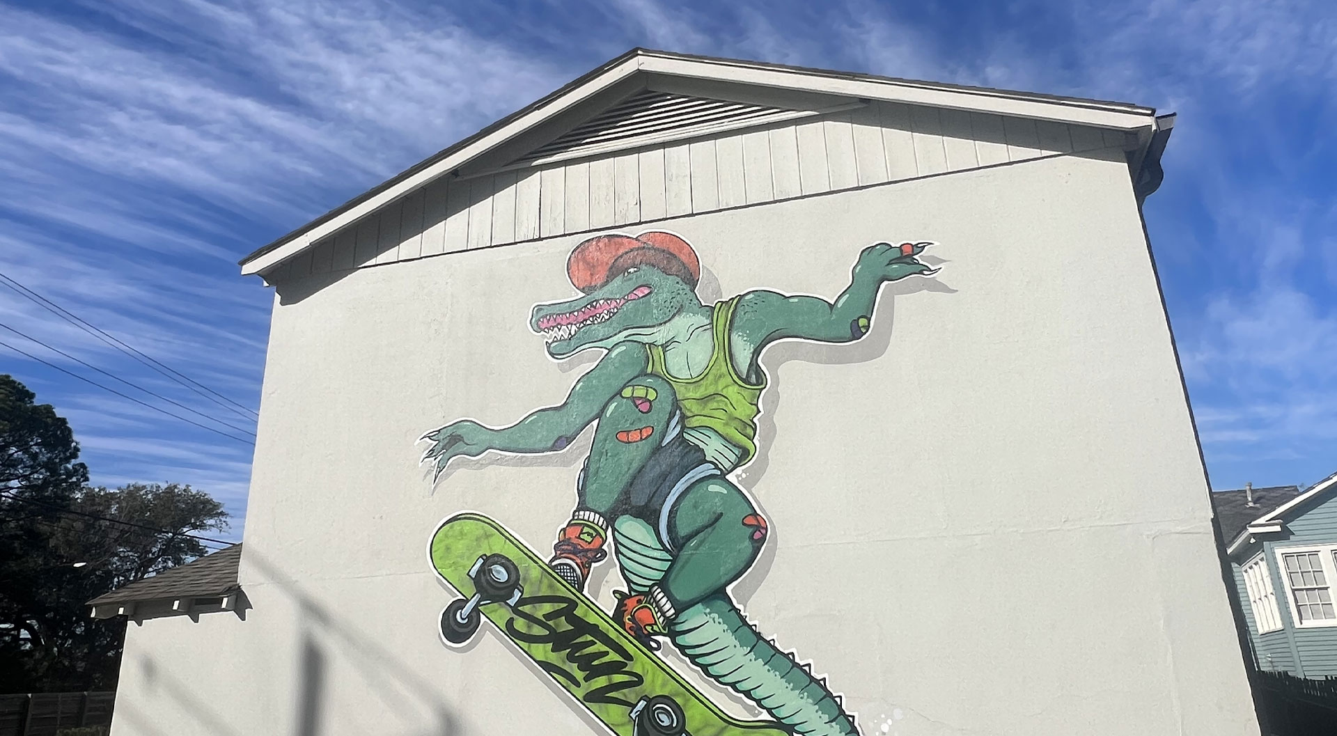 Mural of alligator on skateboard on the side of STUN Agency's headquarters