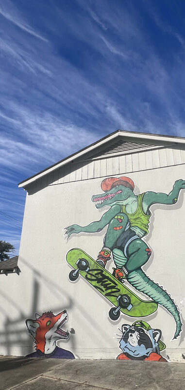 Mural of alligator on skateboard on the side of STUN Agency's headquarters